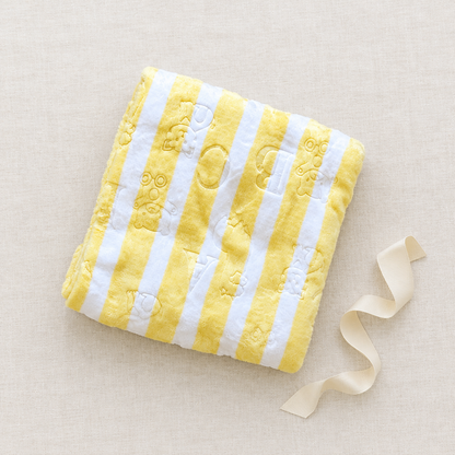 Yellow striped blanket gift styling